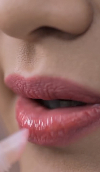 Maquillaje de labios coral con efecto gloss